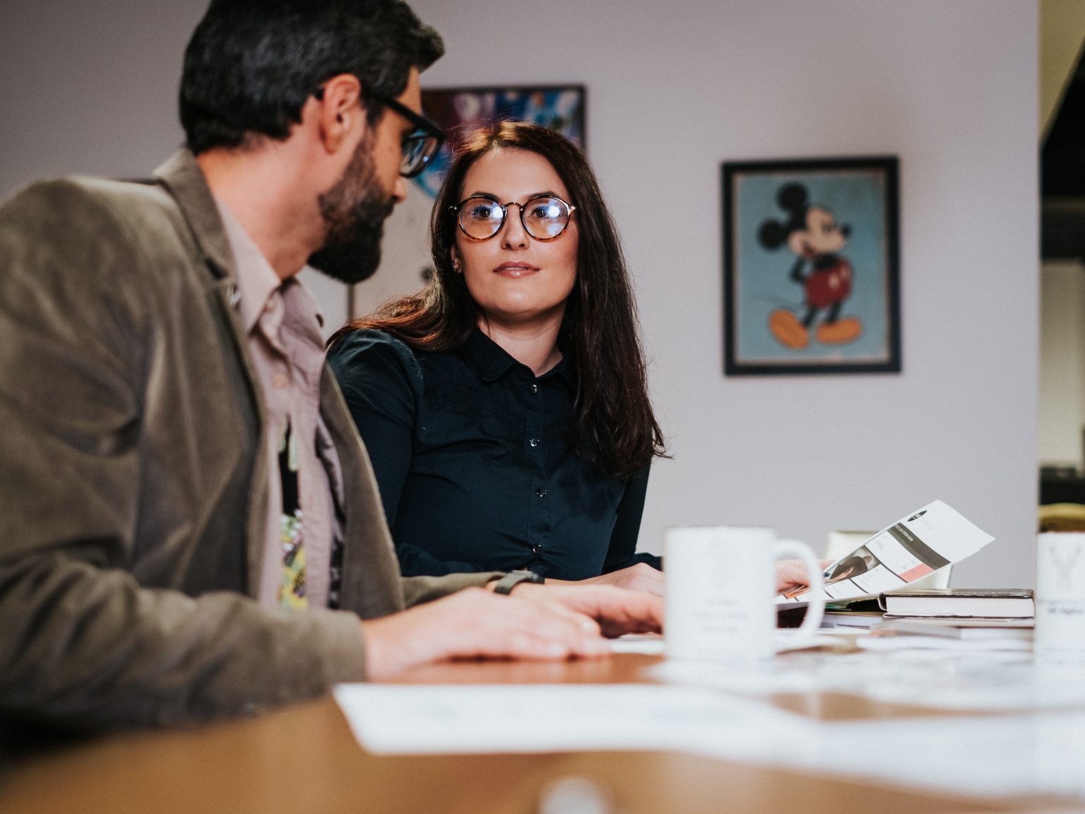 A businessman and woman, who William Smith of Double Iron Consulting can help, sit at a table